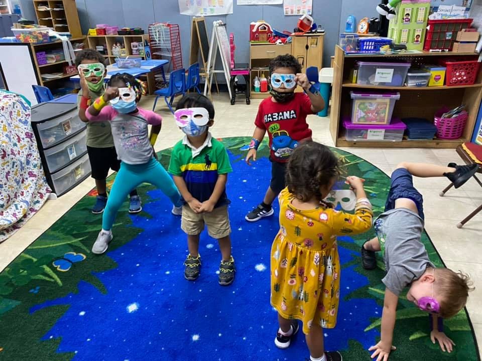 Children wearing masks and face coverings in a classroom