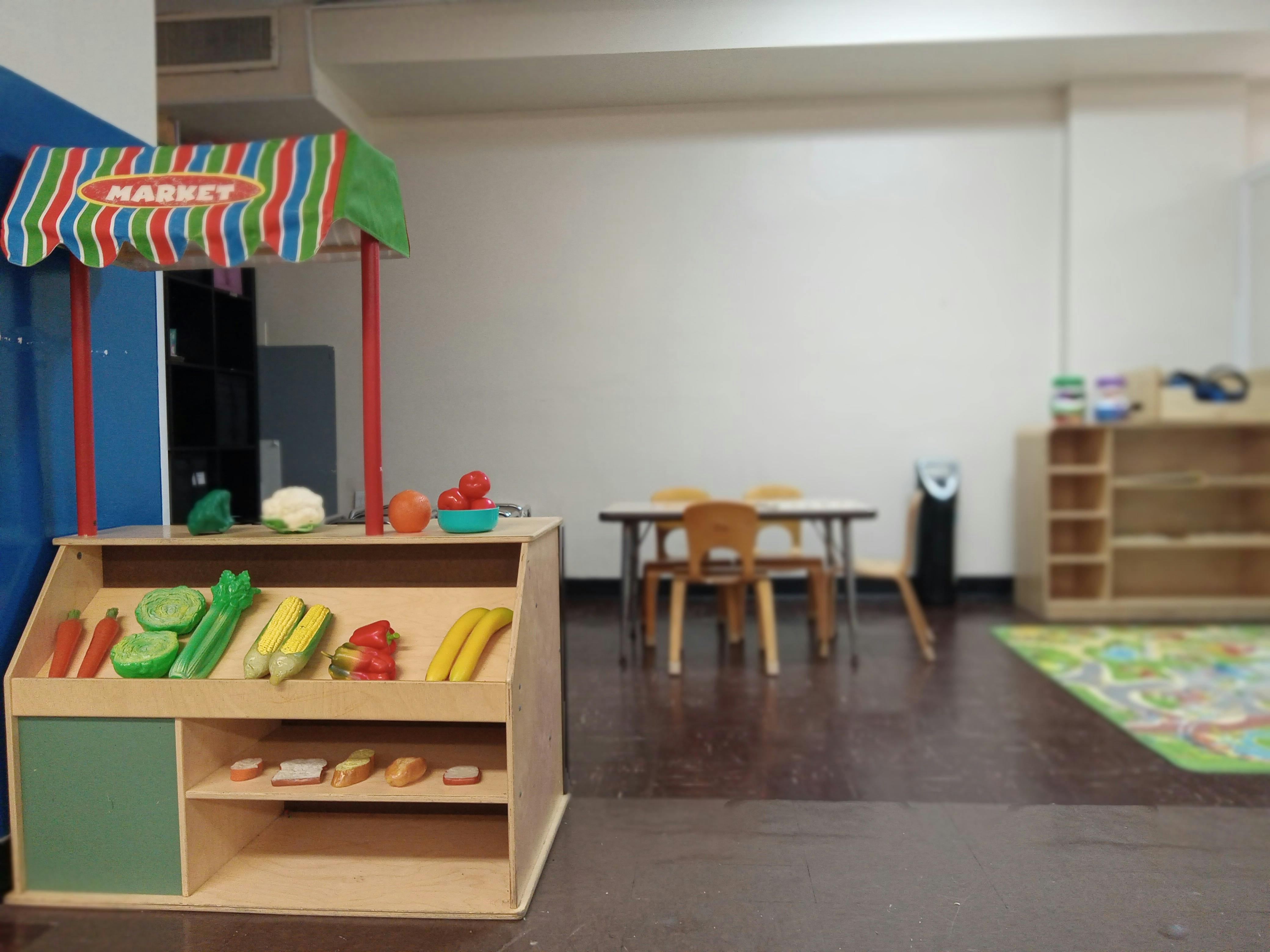 Toy market stand with play food in a classroom