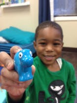Child holding a blue toy