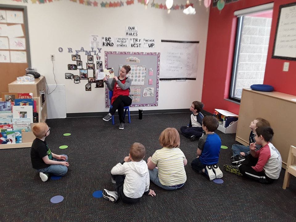 Person reading to children in a classroom