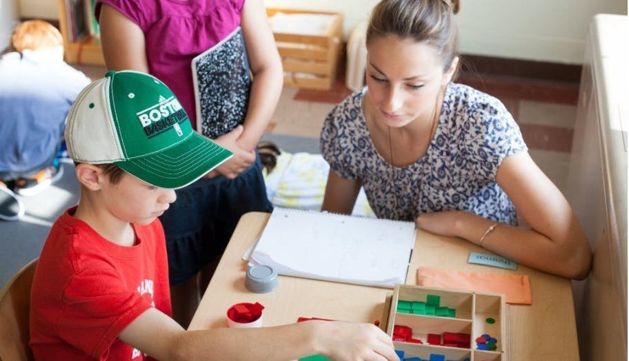 Adult and child at a table with learning materials