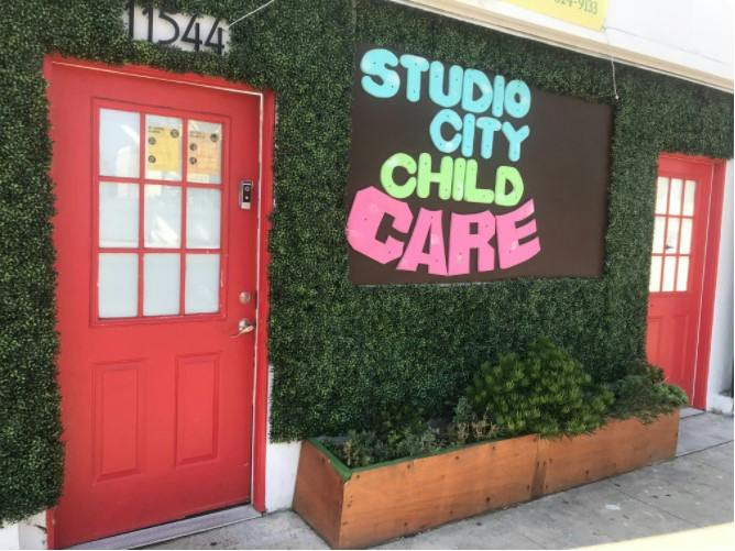 Entrance to Studio City Child Care with red doors and ivy covered walls