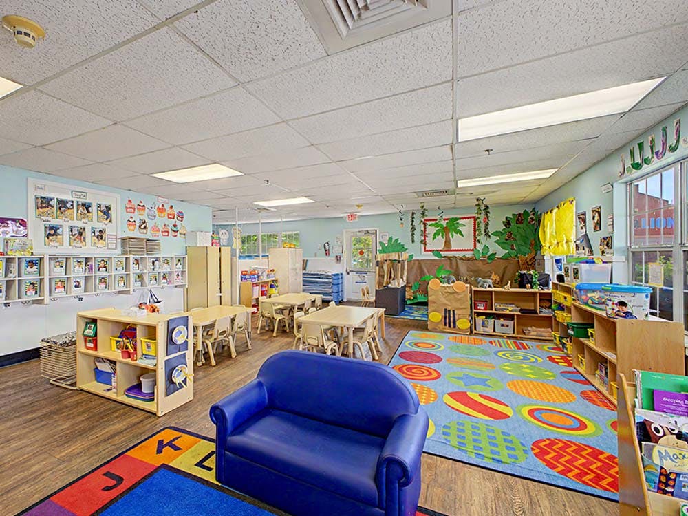 Colorful classroom with child-sized furniture and play areas