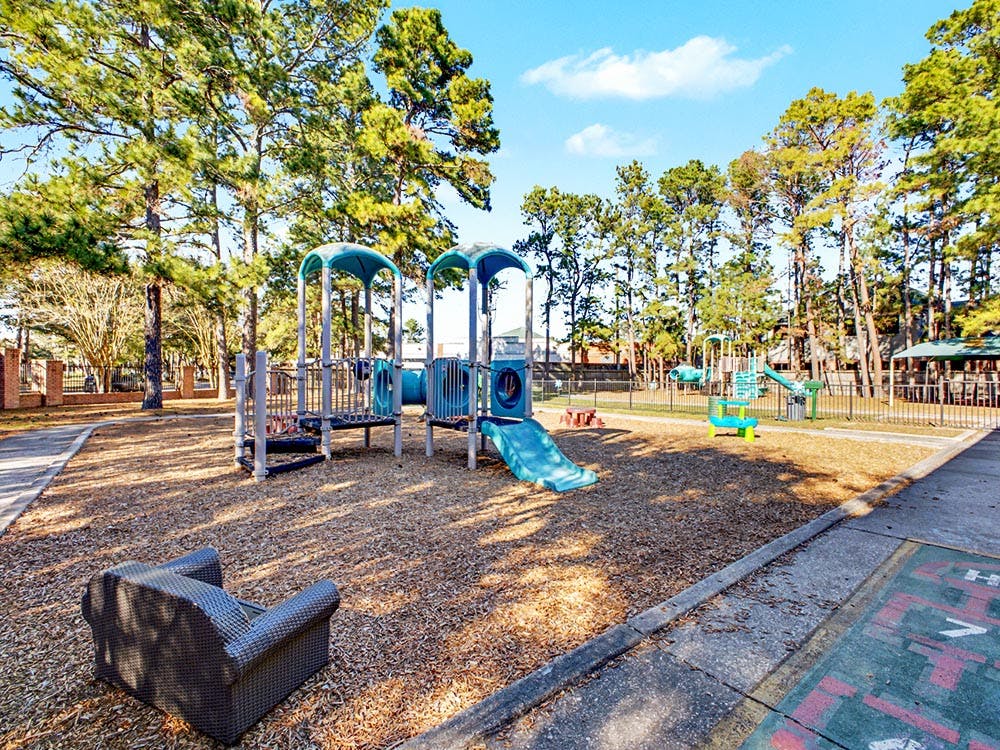 An outdoor playground with swings, slides, and climbing structures