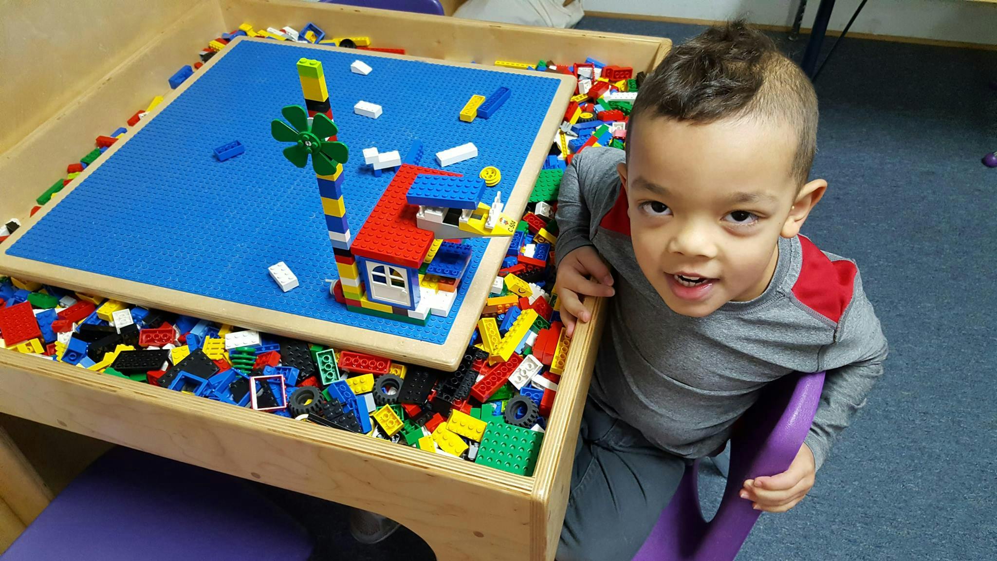 Child sitting at a table with building blocks