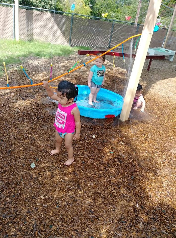 Children playing with water in an outdoor area