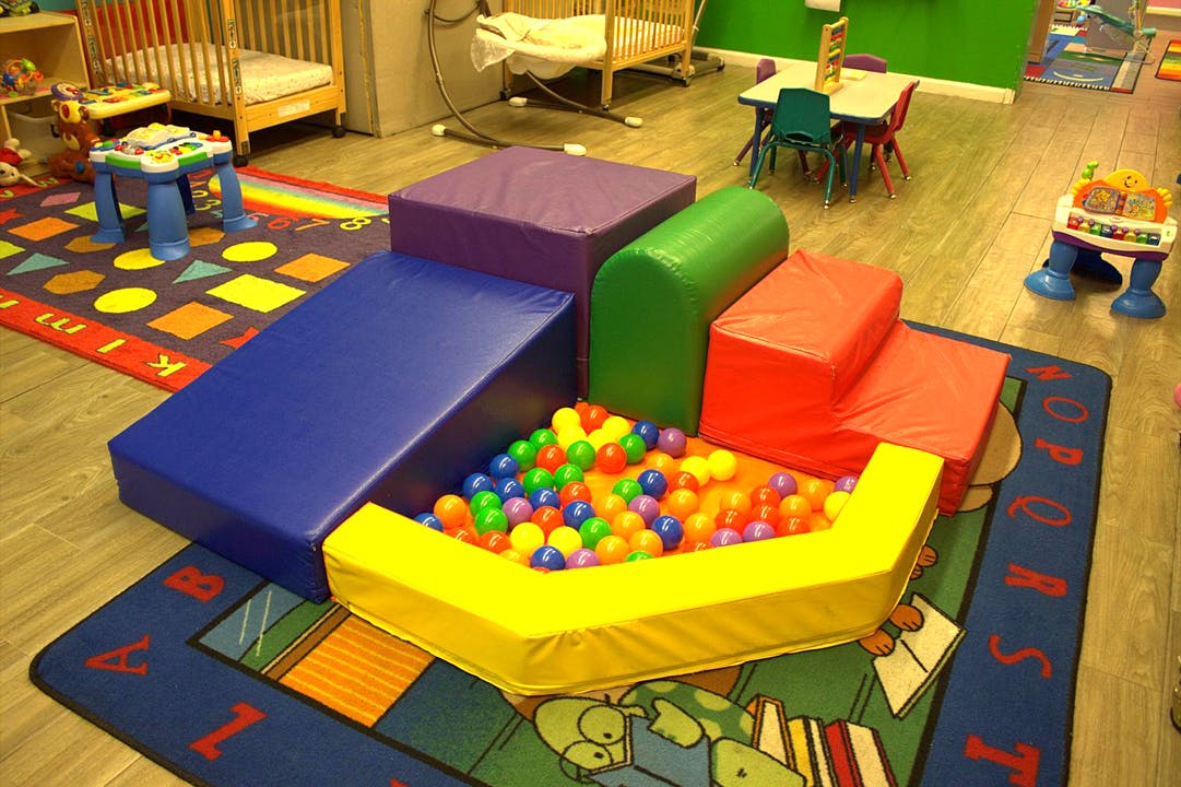 Indoor soft play area with a ball pit and colorful foam blocks