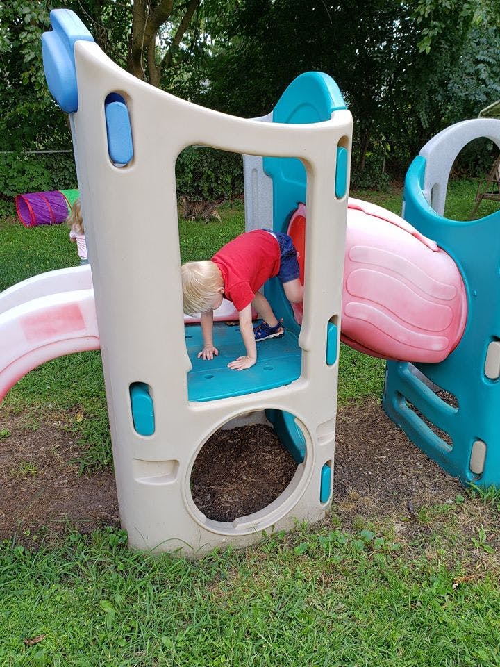 Child crawling through a play structure