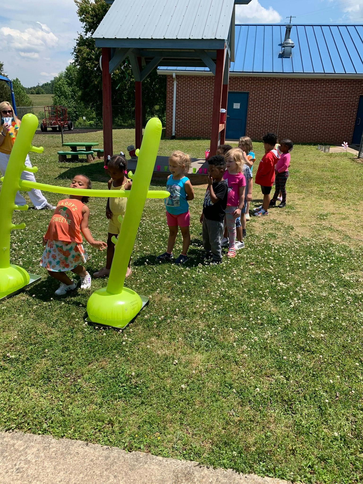 Children playing limbo outdoors