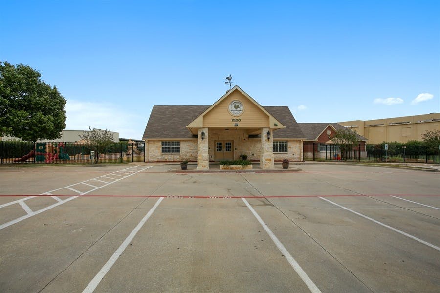 Building with a gabled entrance and a parking lot in front