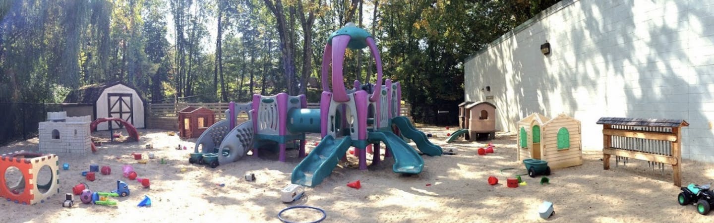 Outdoor playground with slides, climbing structures, and various toys