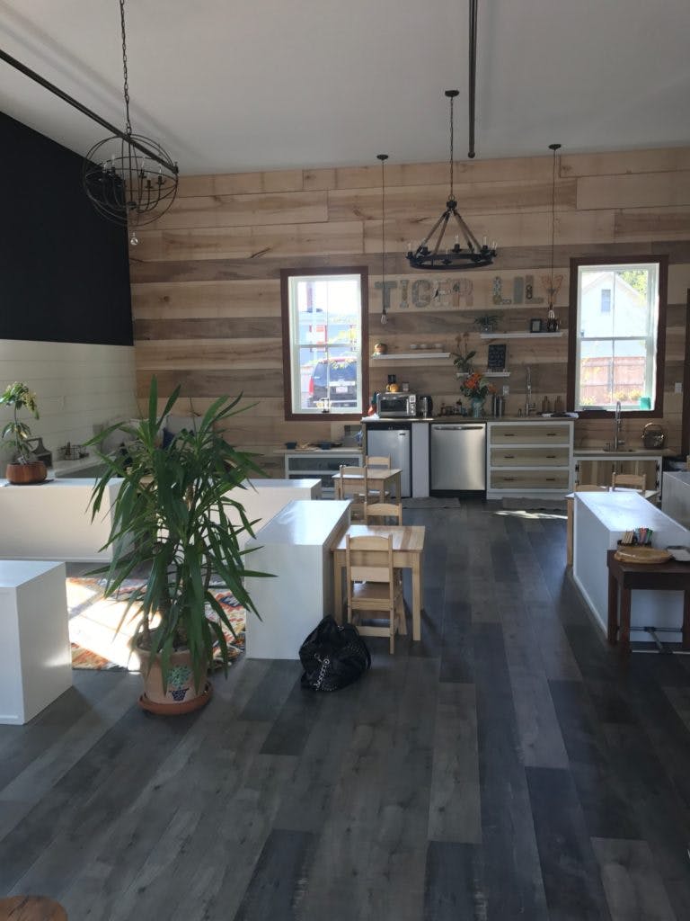 Interior of a room with wooden walls, dark floor, and white counters