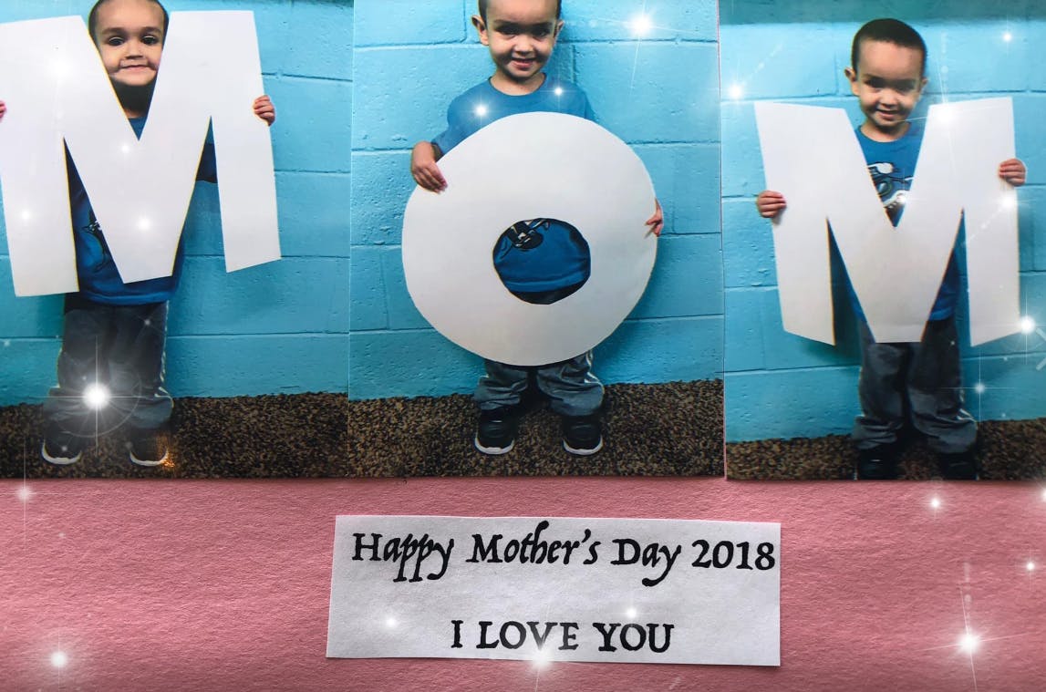 Child holding letters M, O, M, with text "Happy Mother's Day 2018 I LOVE YOU"