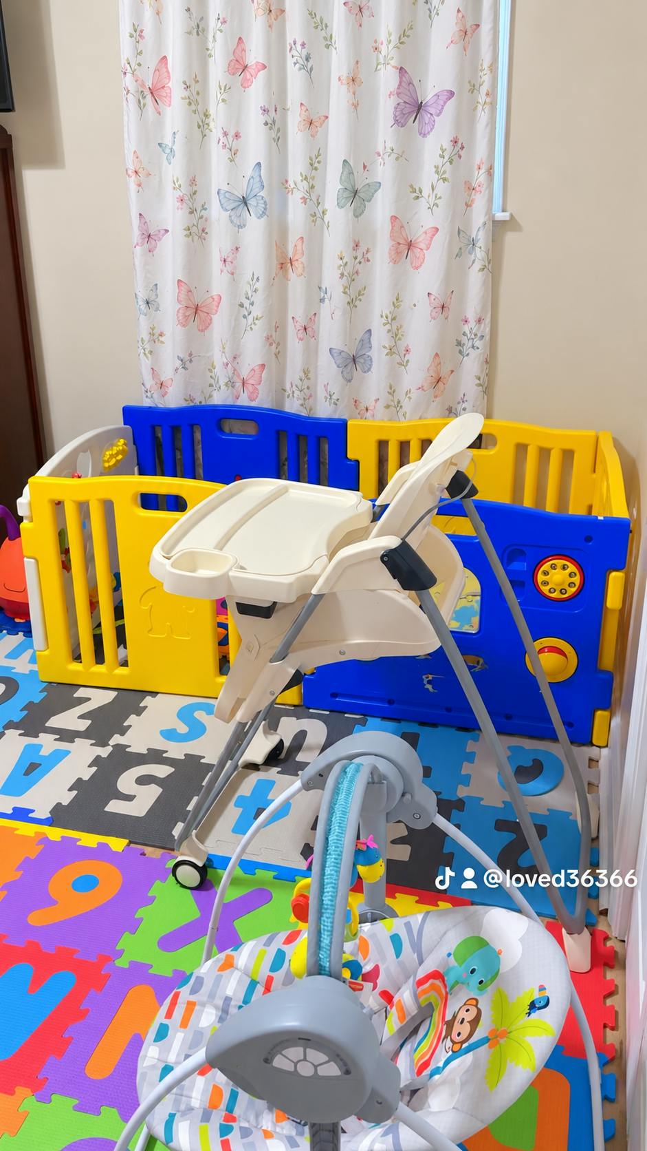 Baby high chair and infant swing in a playroom with puzzle floor mats