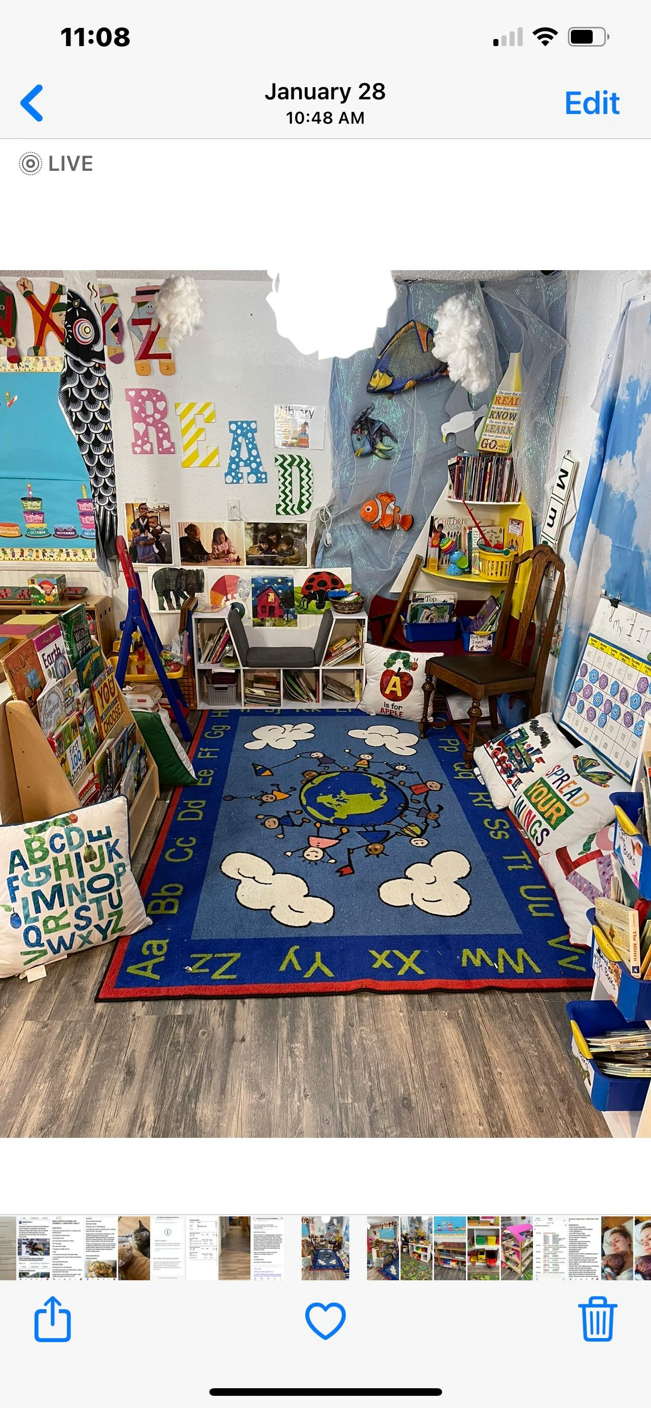 Classroom with a blue rug featuring a globe and alphabet letters