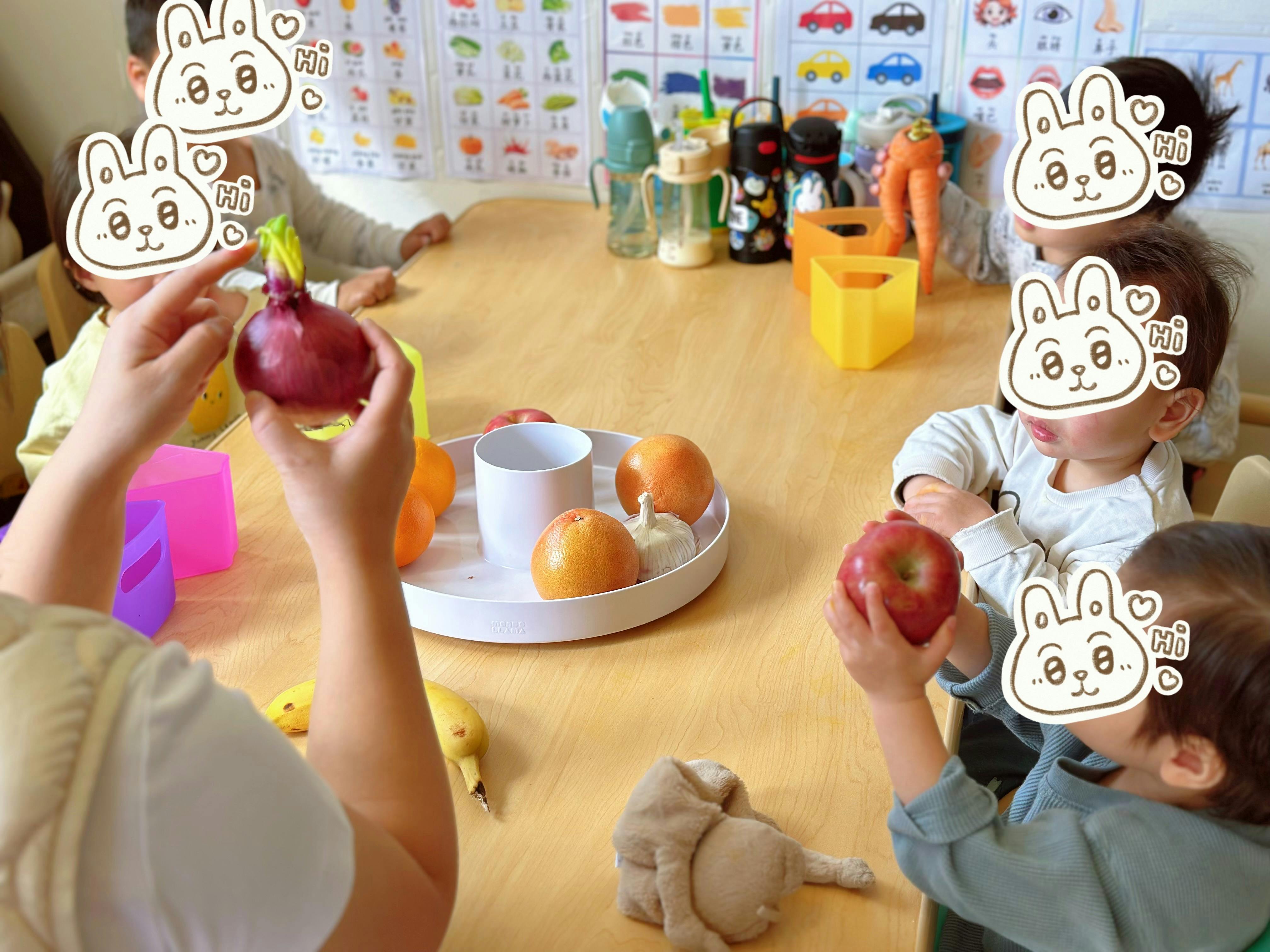 Children learning with fruit and vegetables on a table in a classroom