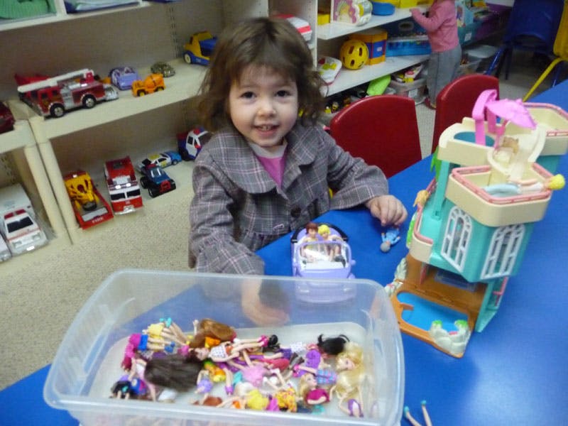 Child playing with toys at a table