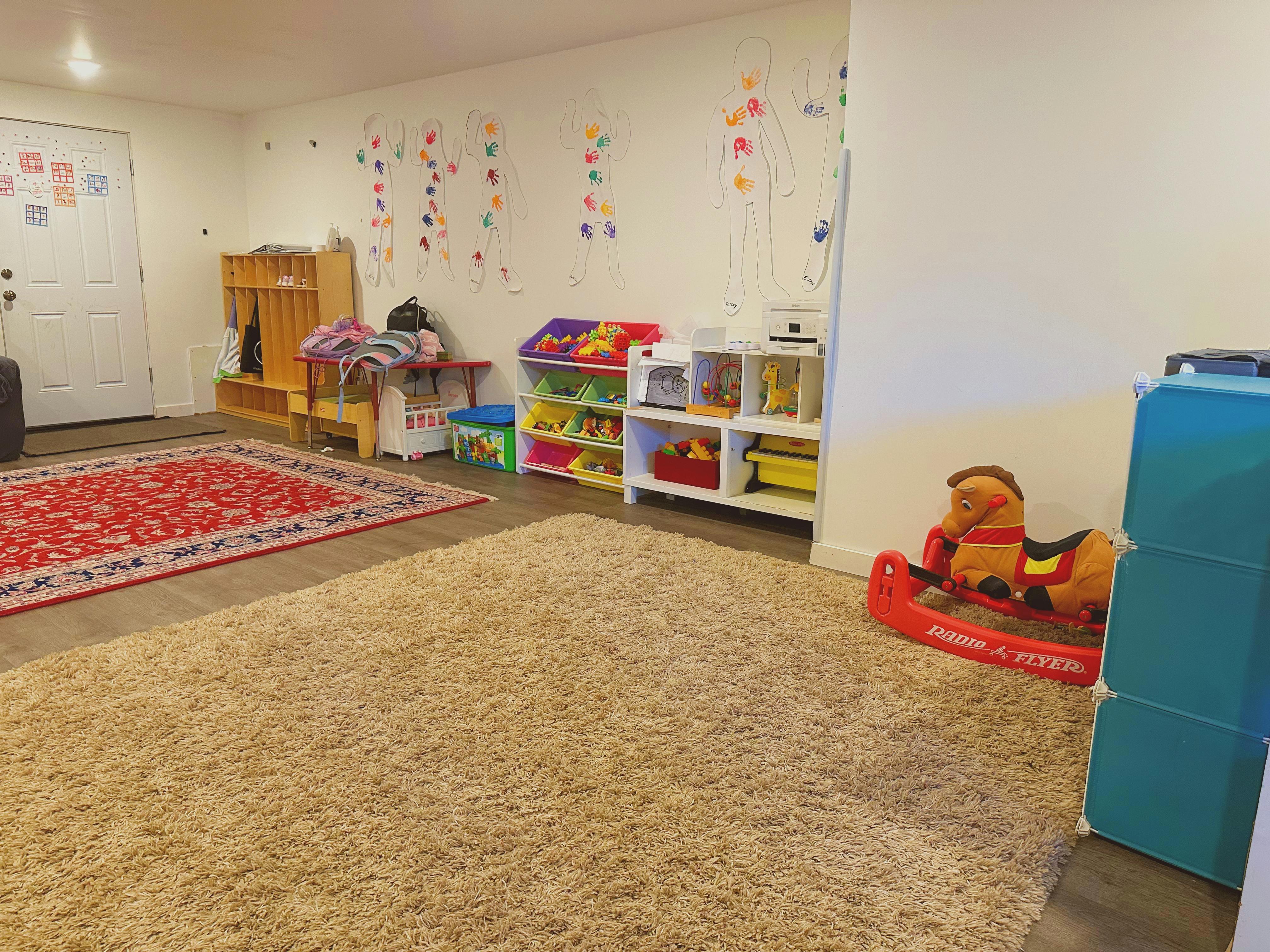 Playroom with toys, shelves, and a rocking horse
