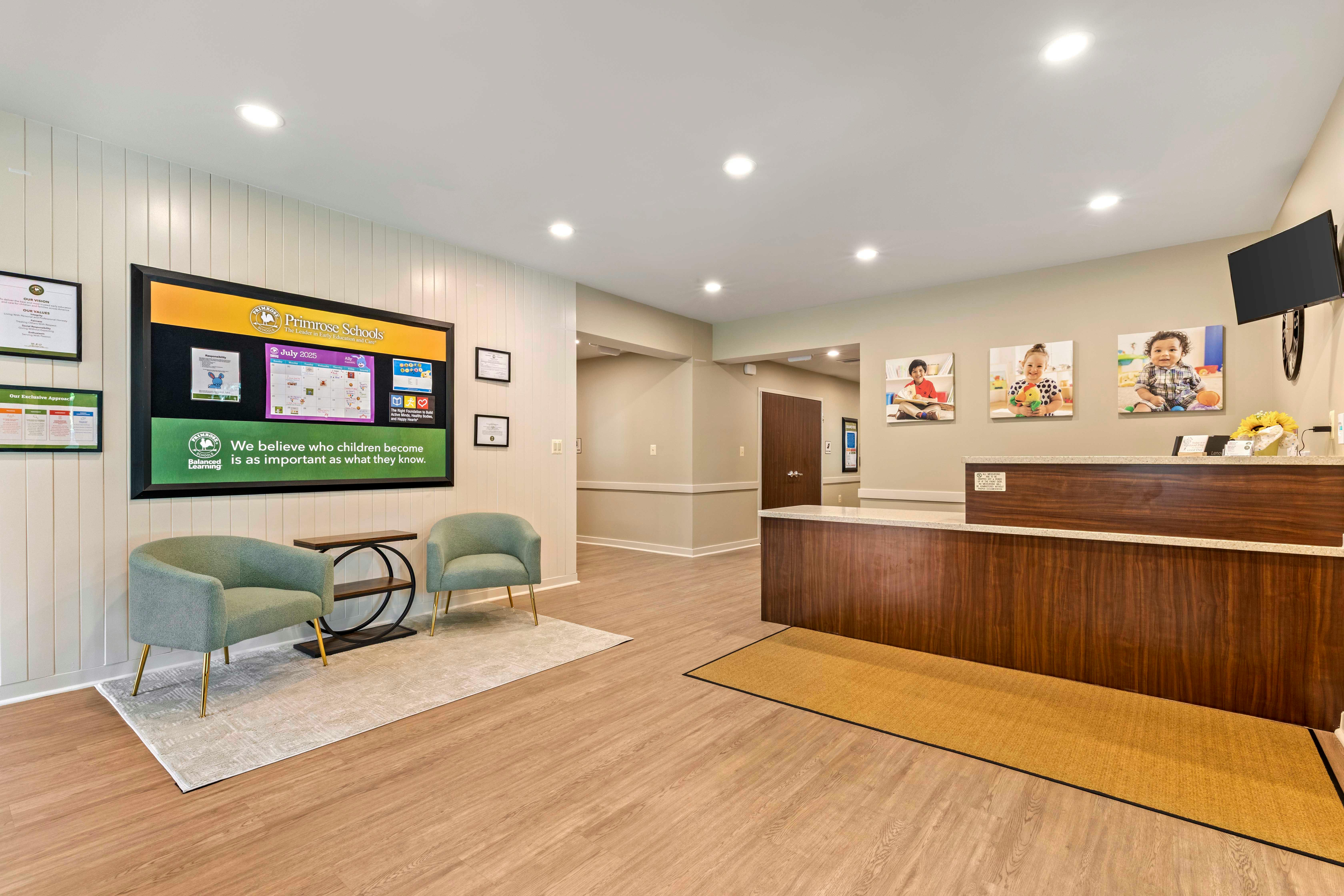 Lobby of a school with a reception desk and a waiting area with two chairs