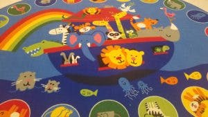 Noah's Ark with animals and a rainbow on a blue background
