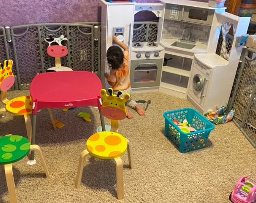 Child playing with a toy kitchen set