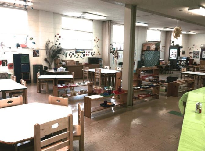 Empty classroom with small tables and chairs