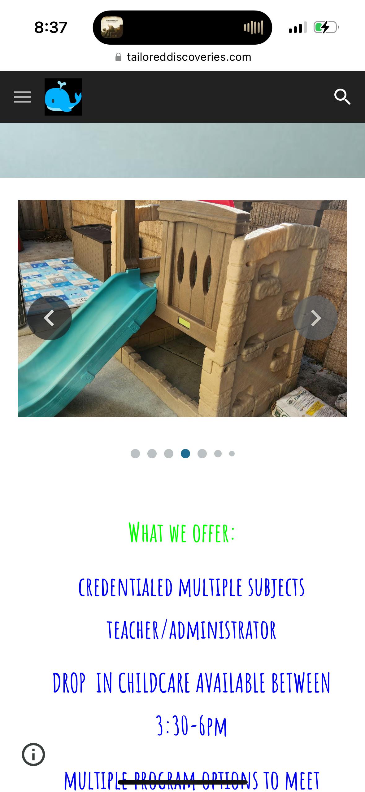 Play structure with a green slide and climbing wall