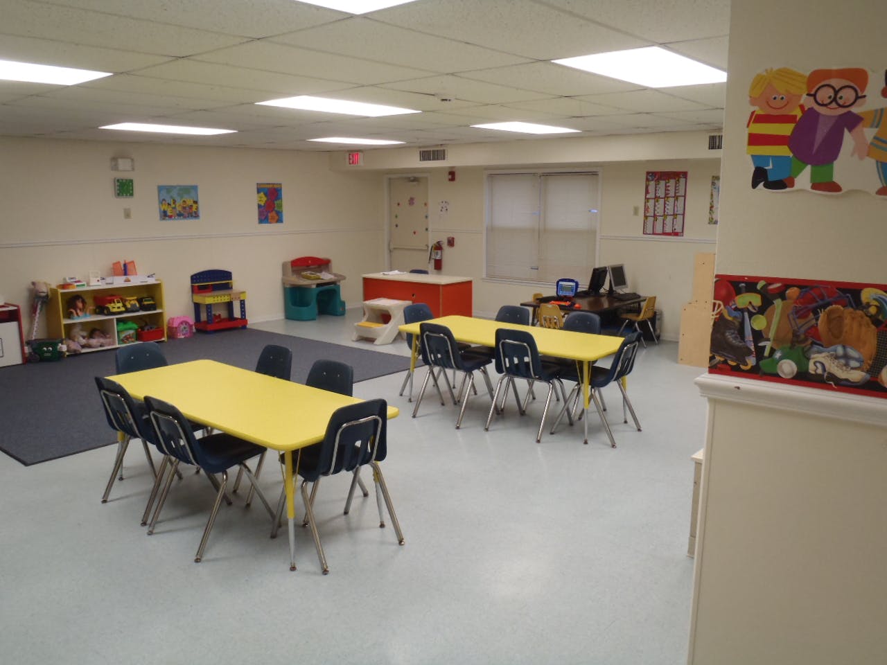 Empty classroom with yellow tables and chairs