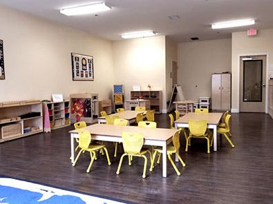 Classroom with small tables and yellow chairs