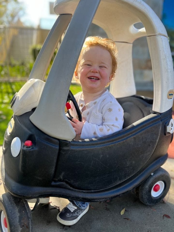 Child in a toy car