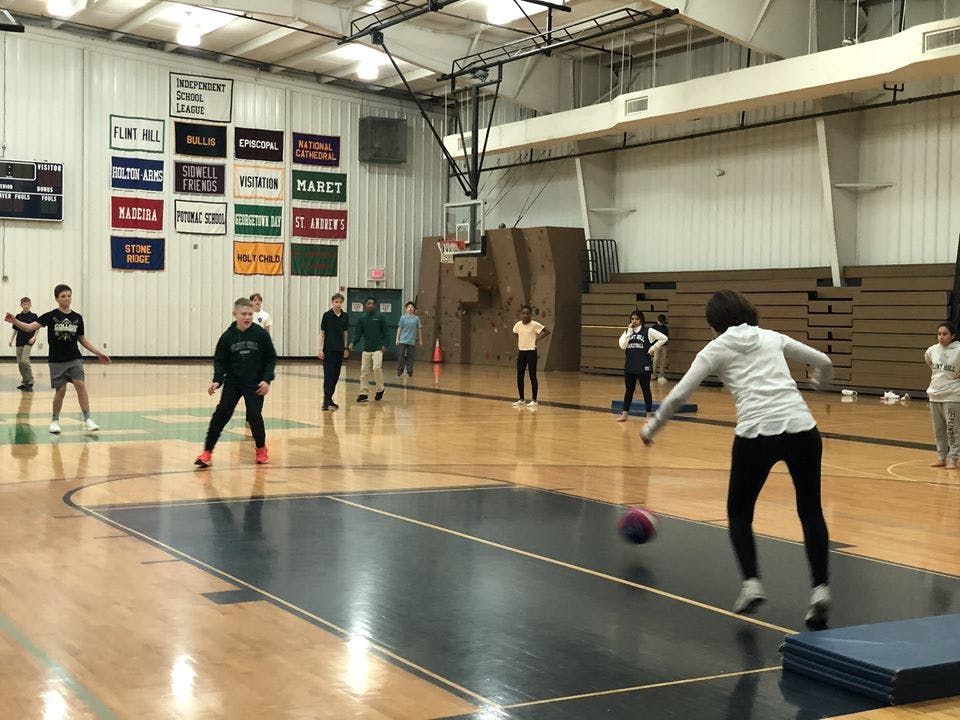 People playing dodgeball in a gymnasium