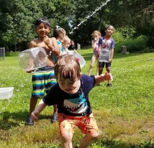 Children playing with water outdoors