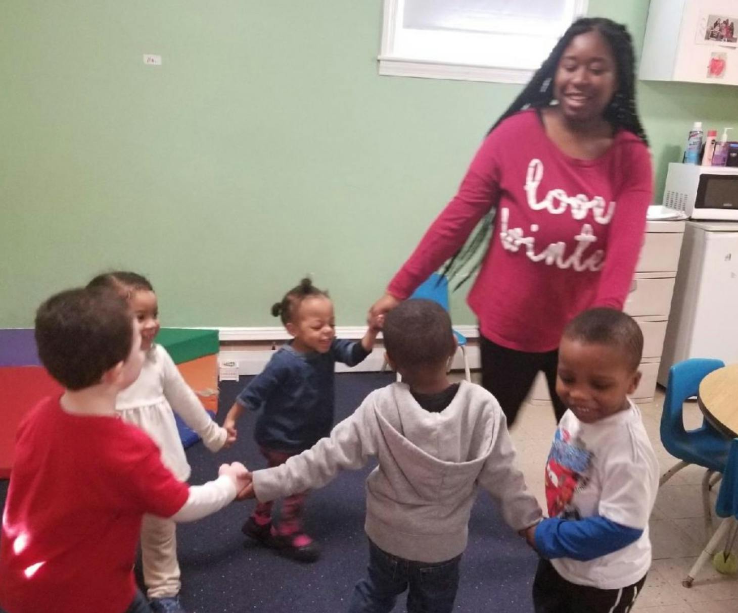 Adult and children holding hands in a circle