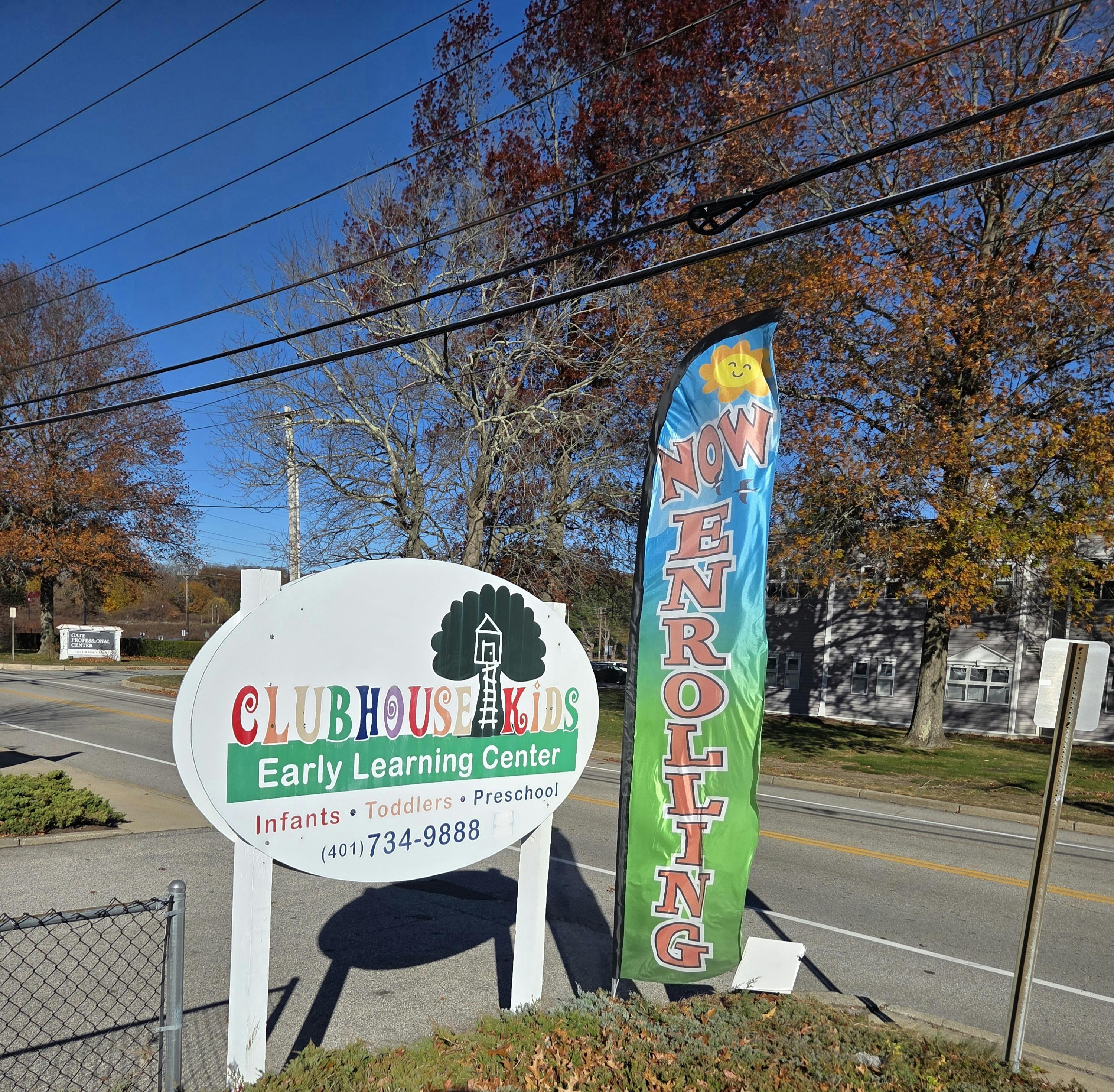 Clubhouse Kids Early Learning Center sign and a Now Enrolling banner