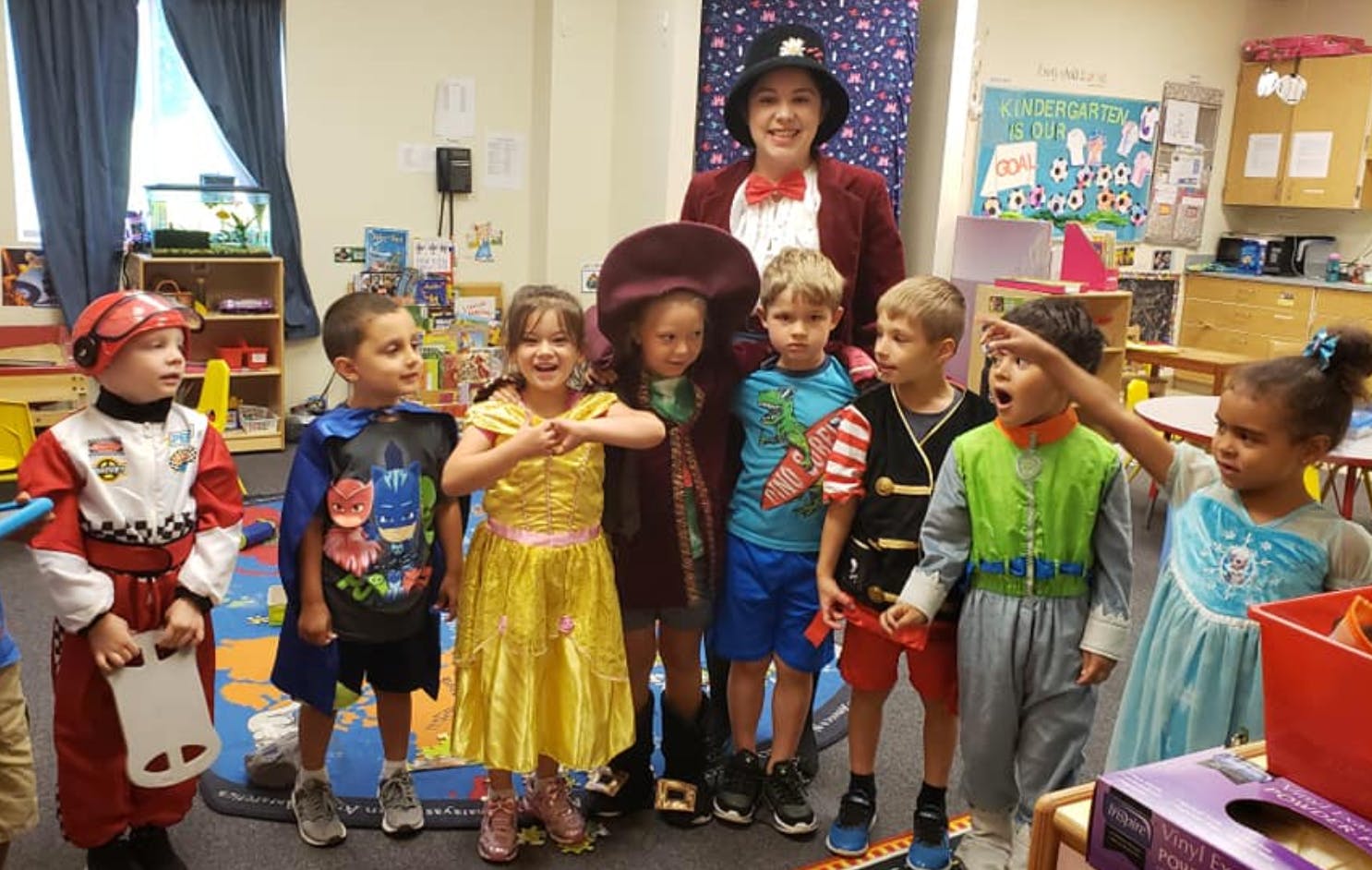 Adult and children in costumes in a classroom