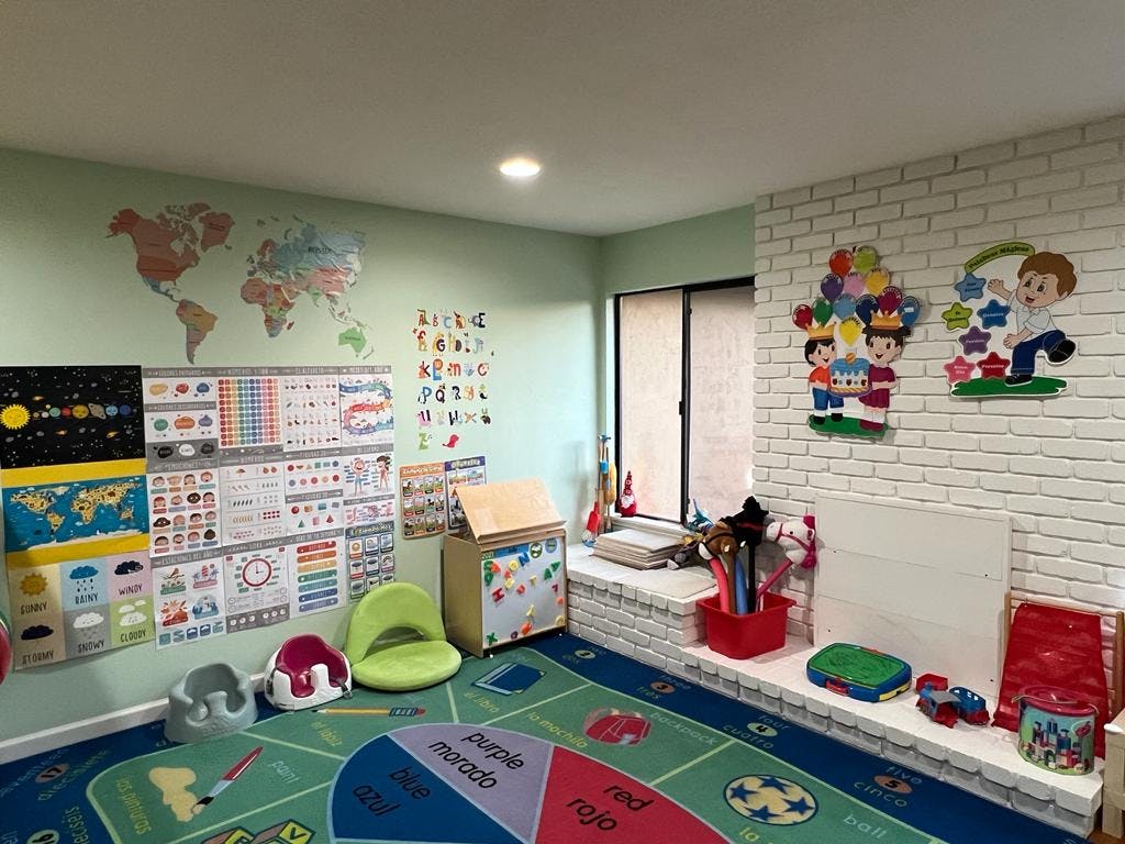 Playroom with educational posters on walls and colorful rug