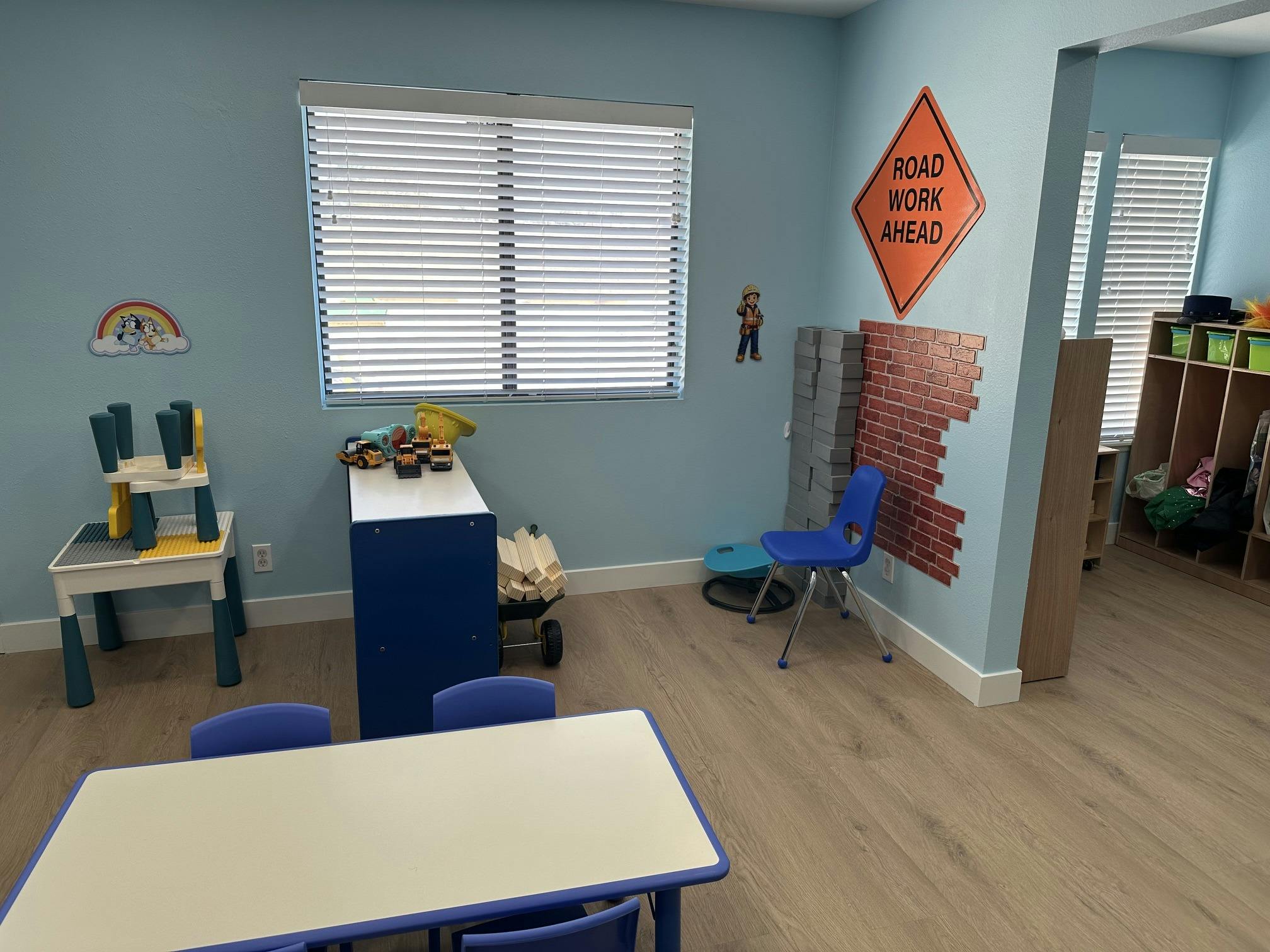 Childcare classroom with construction themed decor and play furniture