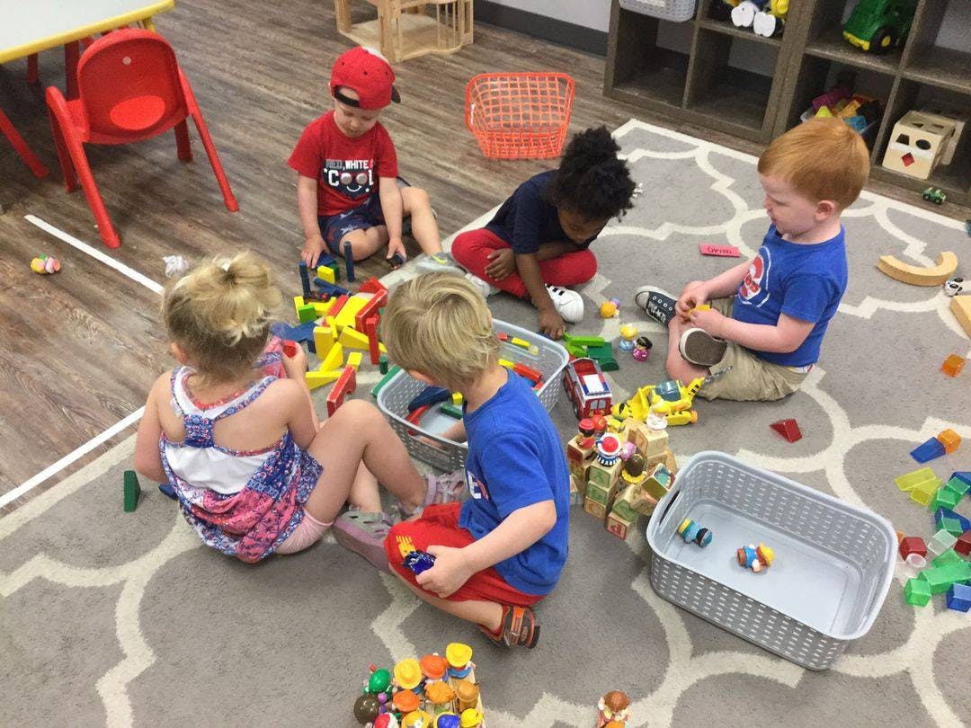 Children playing with toys on a rug