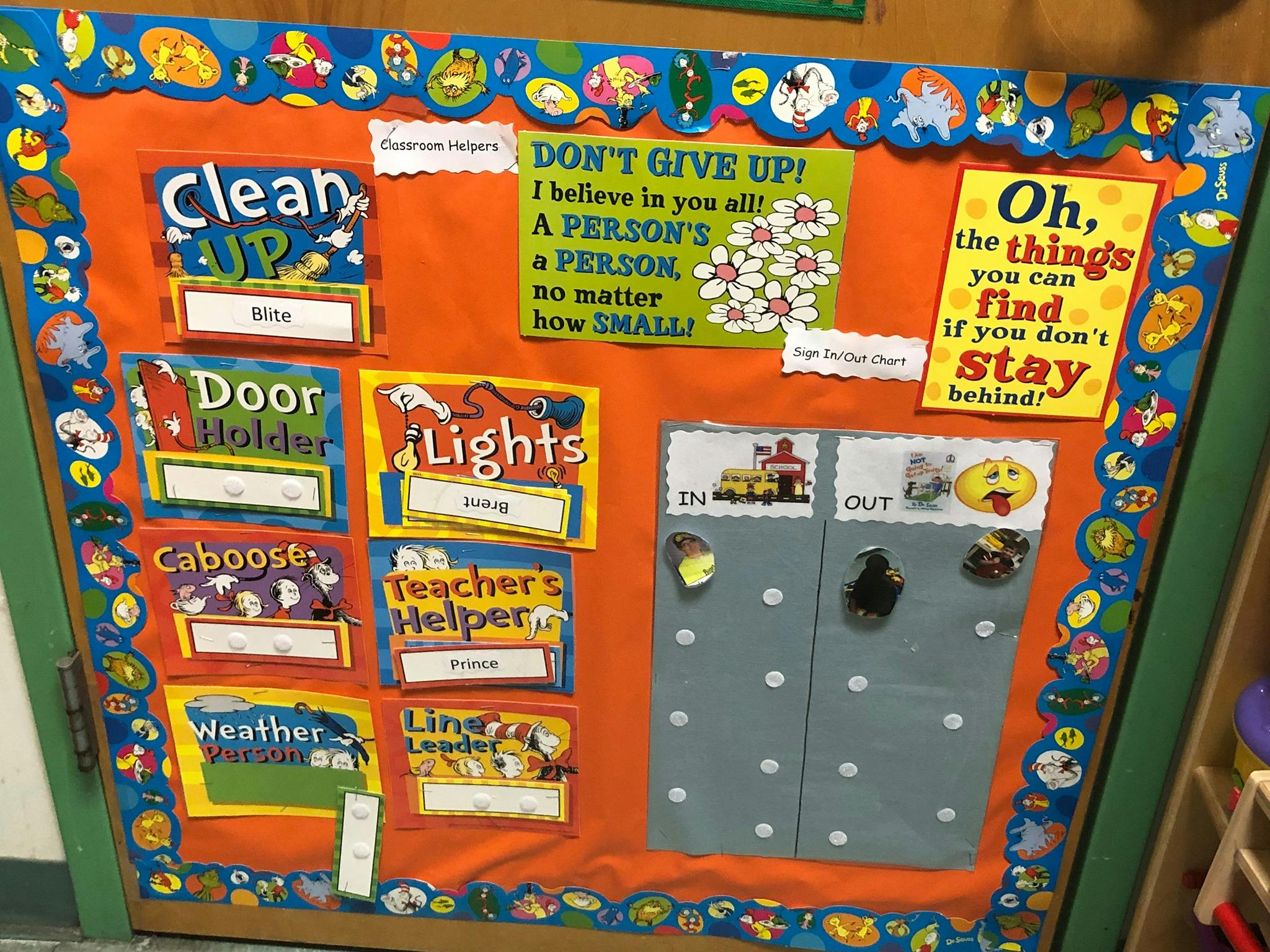 Classroom bulletin board with job chart and motivational signs