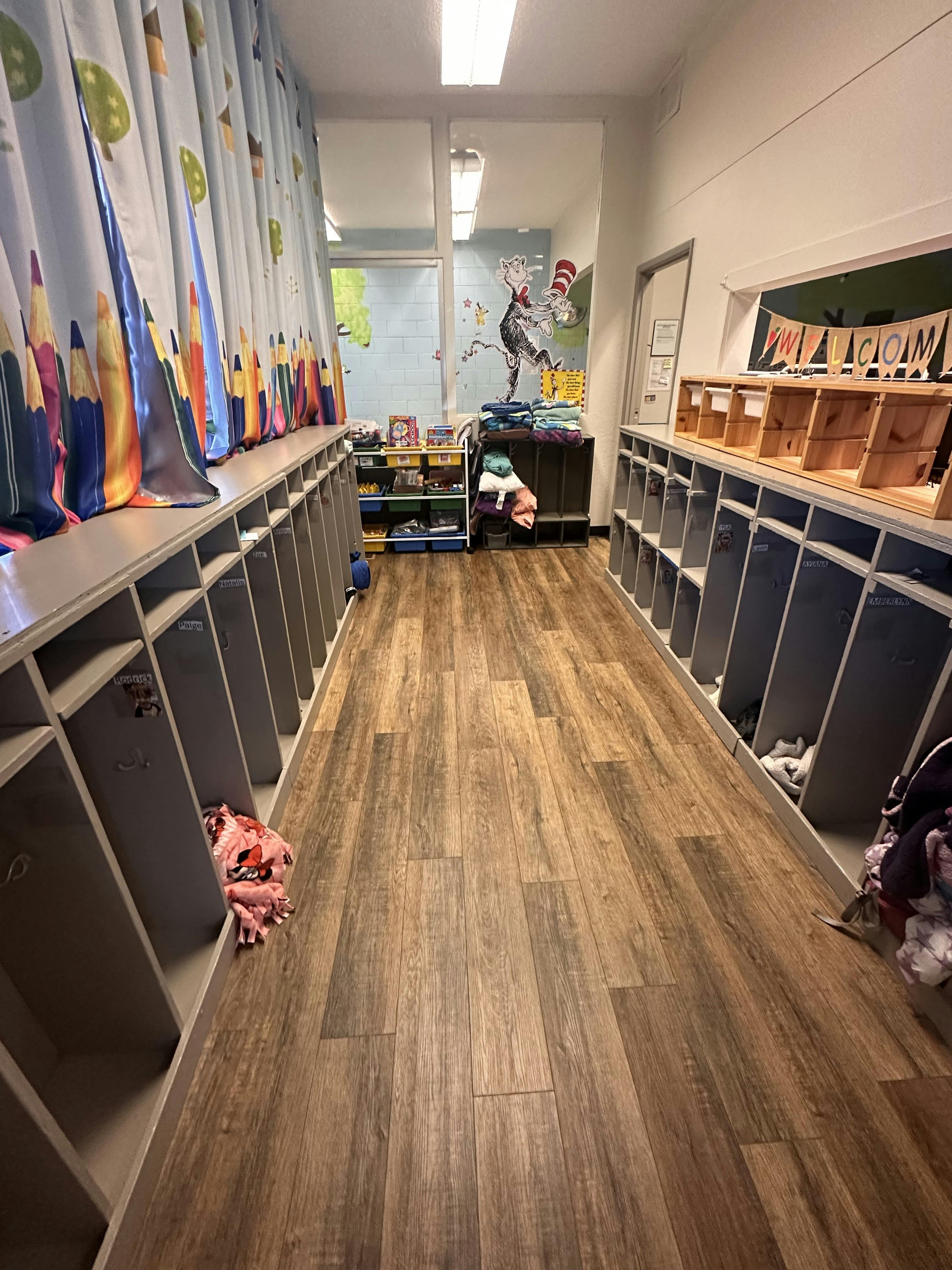 Hallway with cubbies on both sides and a window at the end