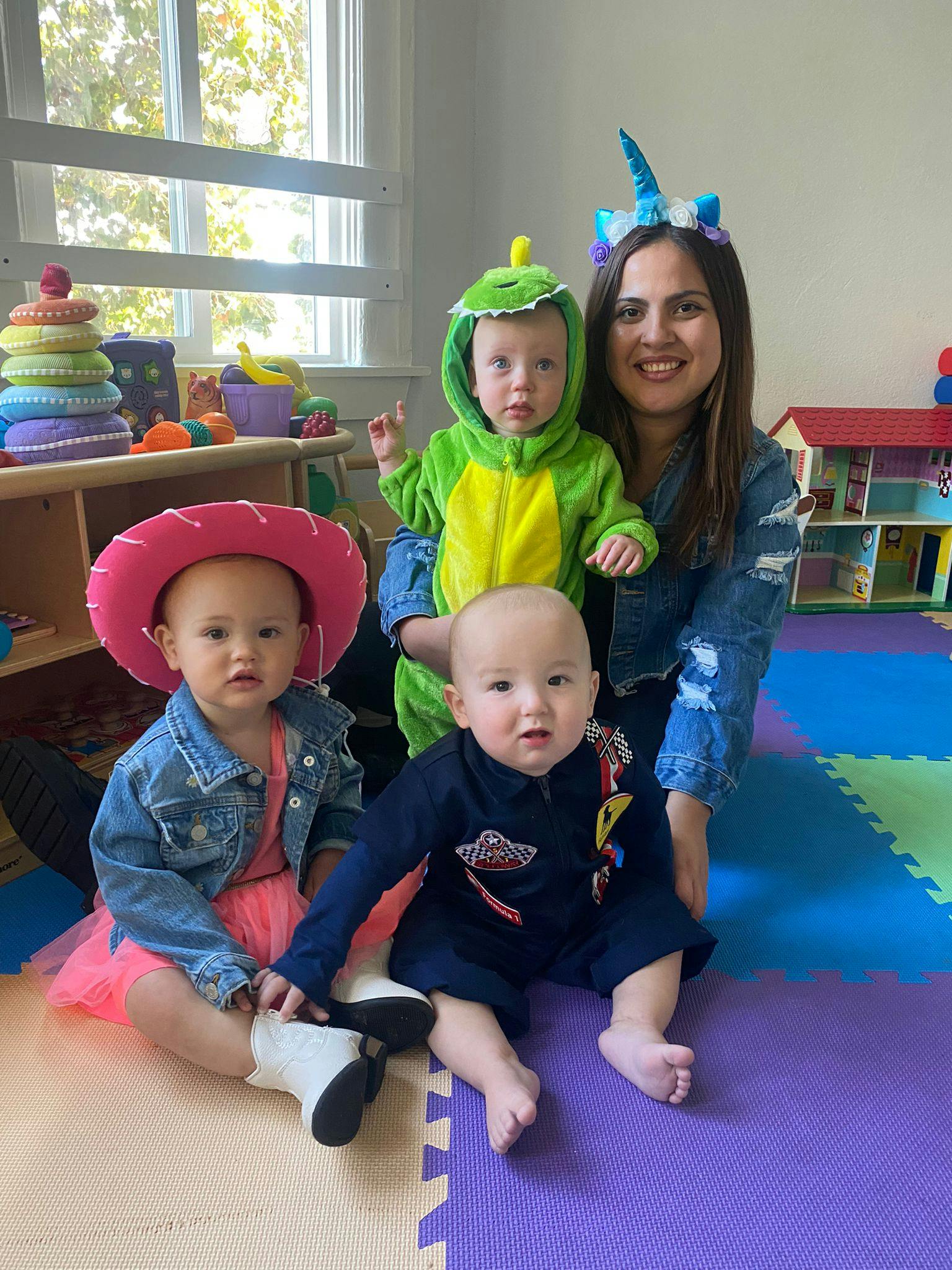 Person with three children in costumes