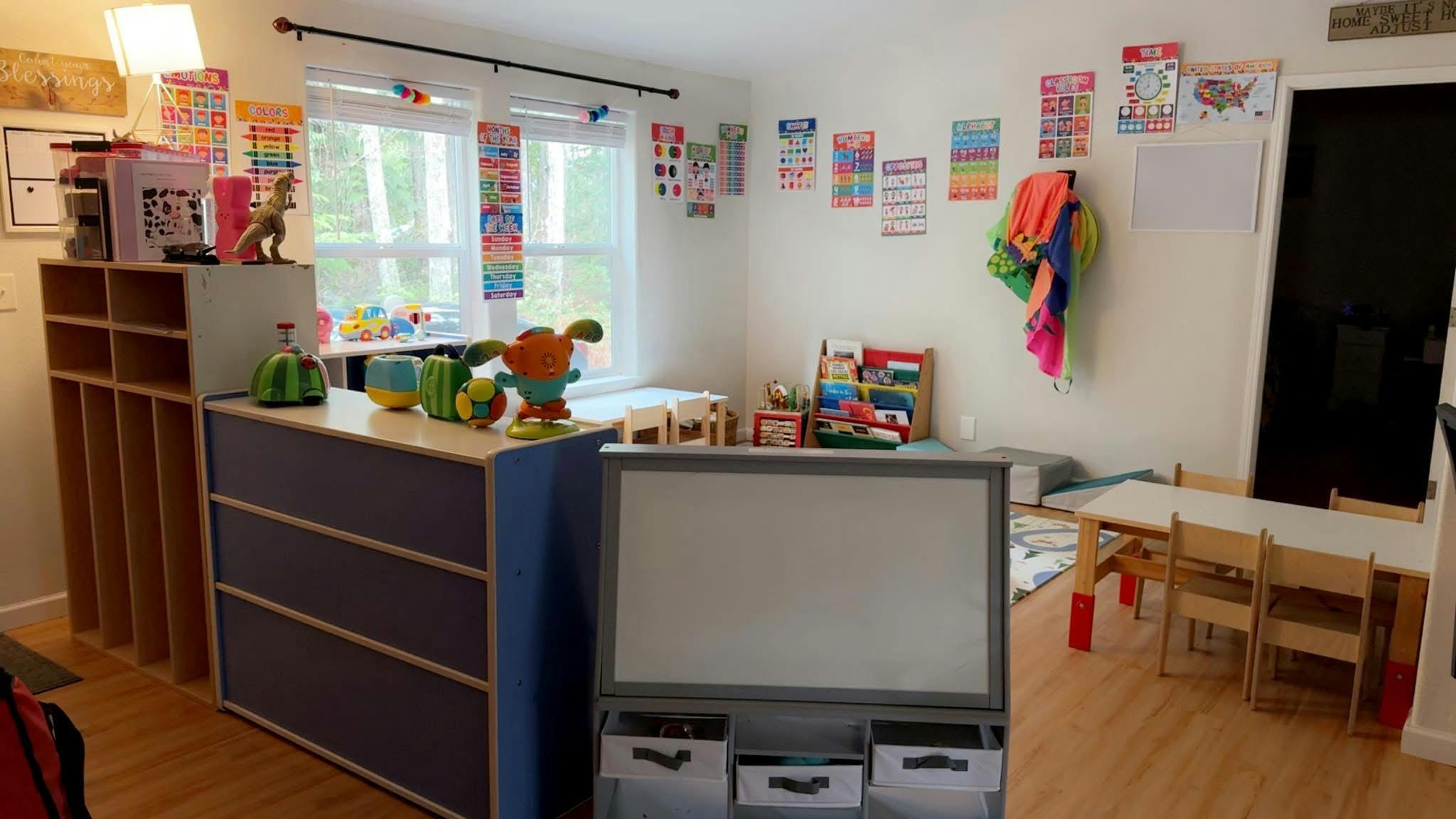 Classroom with small tables, chairs, and learning materials