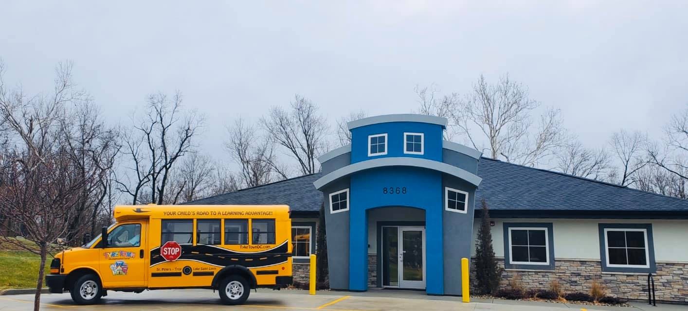 Yellow school bus parked in front of a building