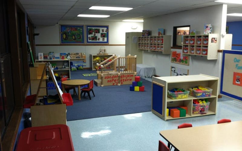 An empty early childhood classroom with colorful toys and furniture