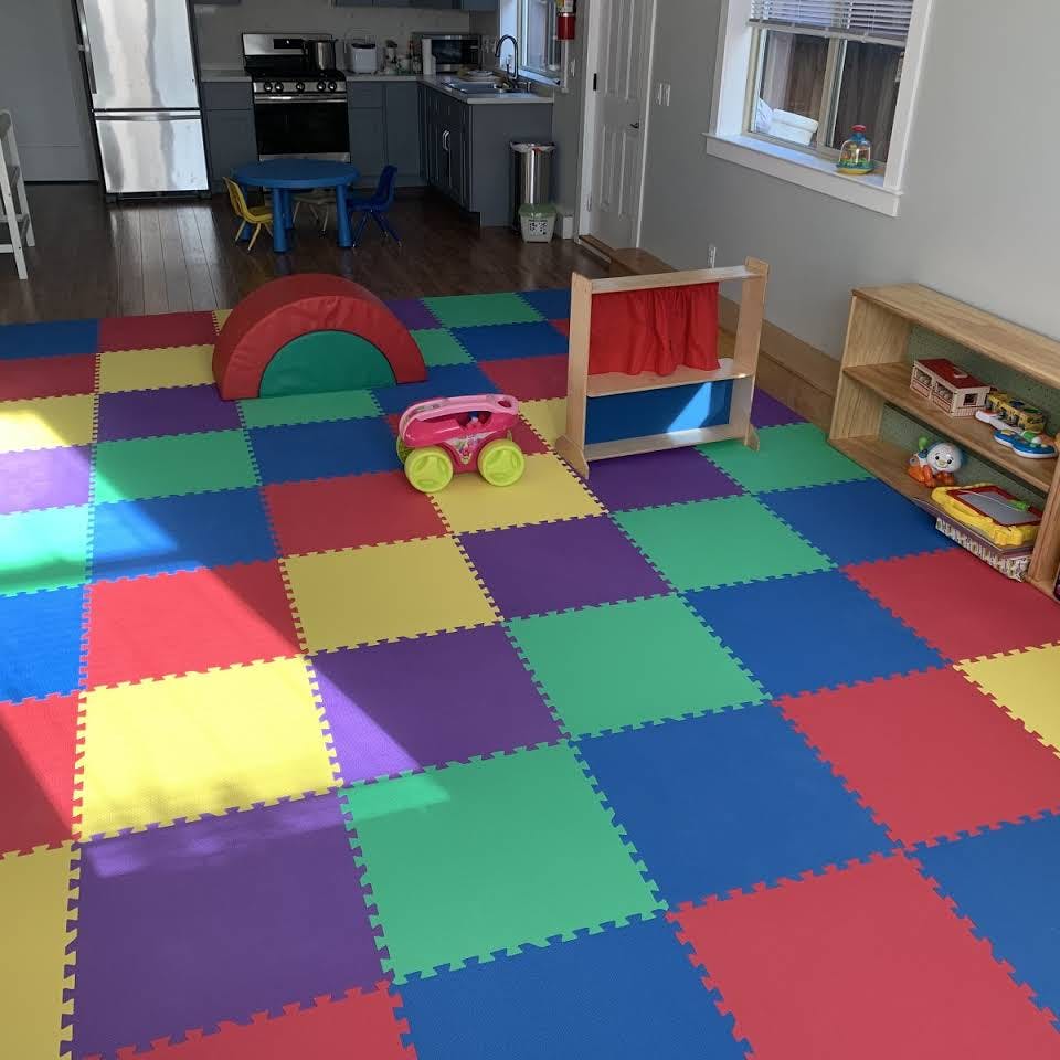 Playroom with colorful interlocking floor mats and various toys