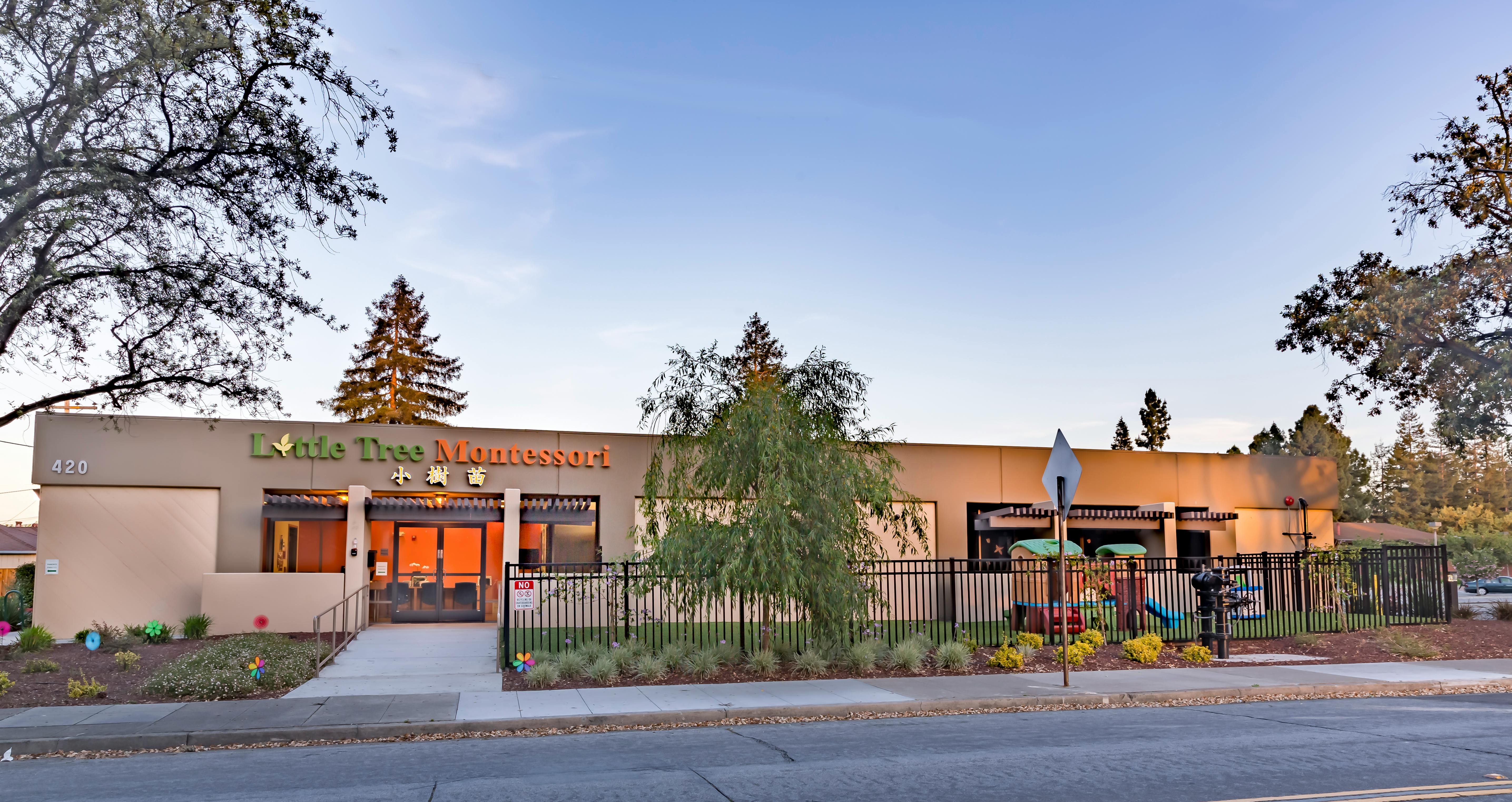 Exterior of the Little Tree Montessori school building with an enclosed yard