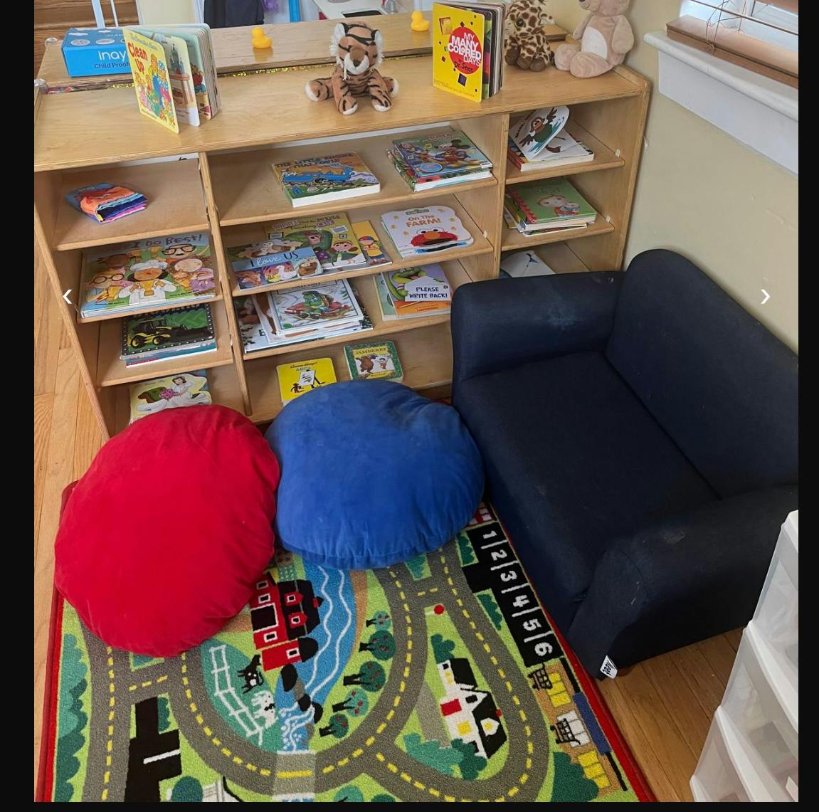 Children's reading nook with bookshelf, beanbags, and small couch
