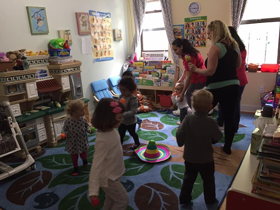 Adults and children interacting in a classroom