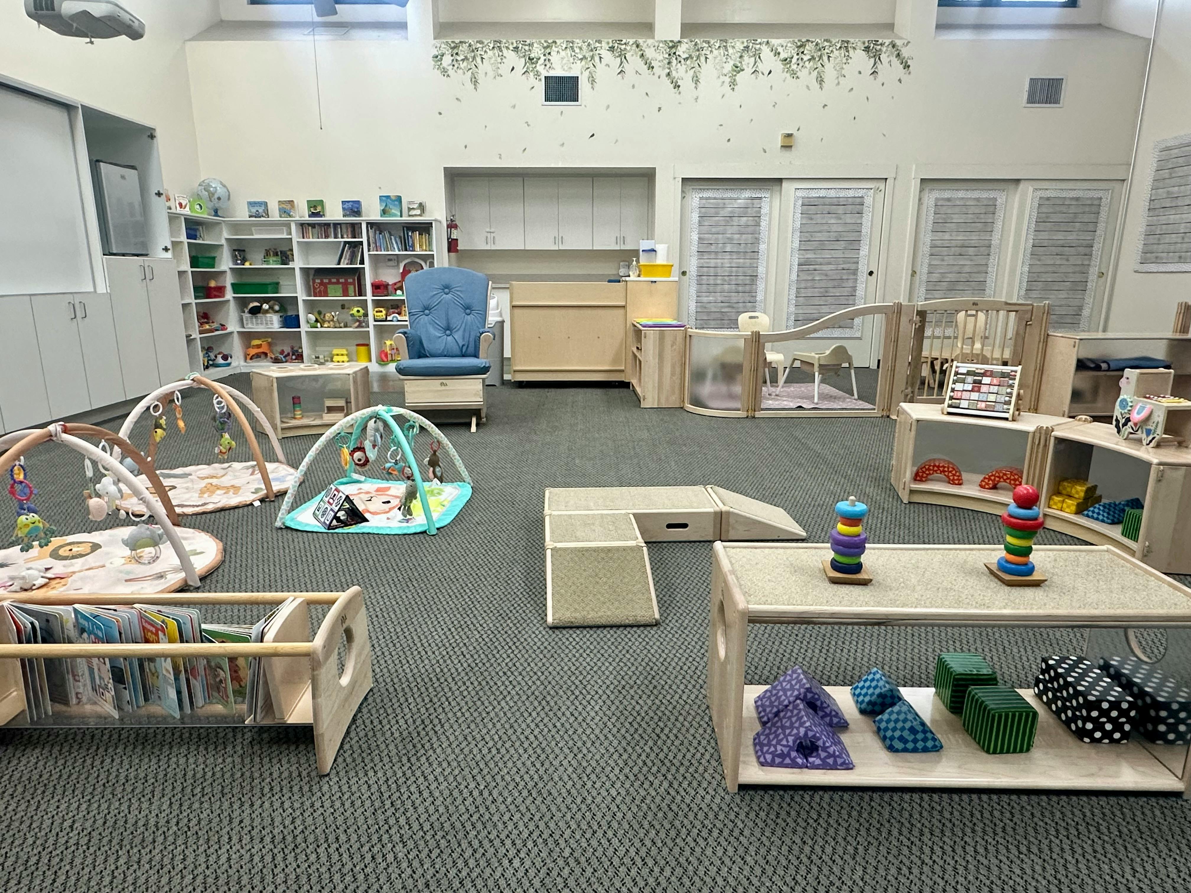 Indoor play area with various child activity stations and furniture