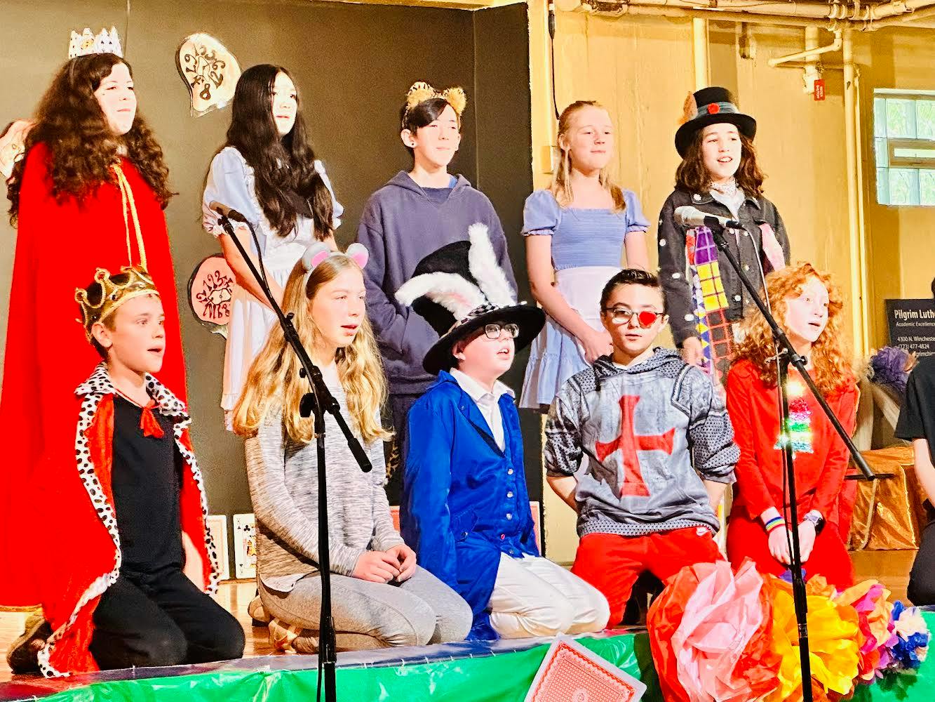 Children and teens in costumes on a stage